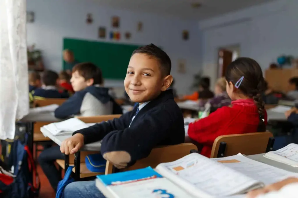 A high school student in 10th or 12th grade smiling in class,representing the positive experience and engagement in educational settings, suitable for distance education courses.