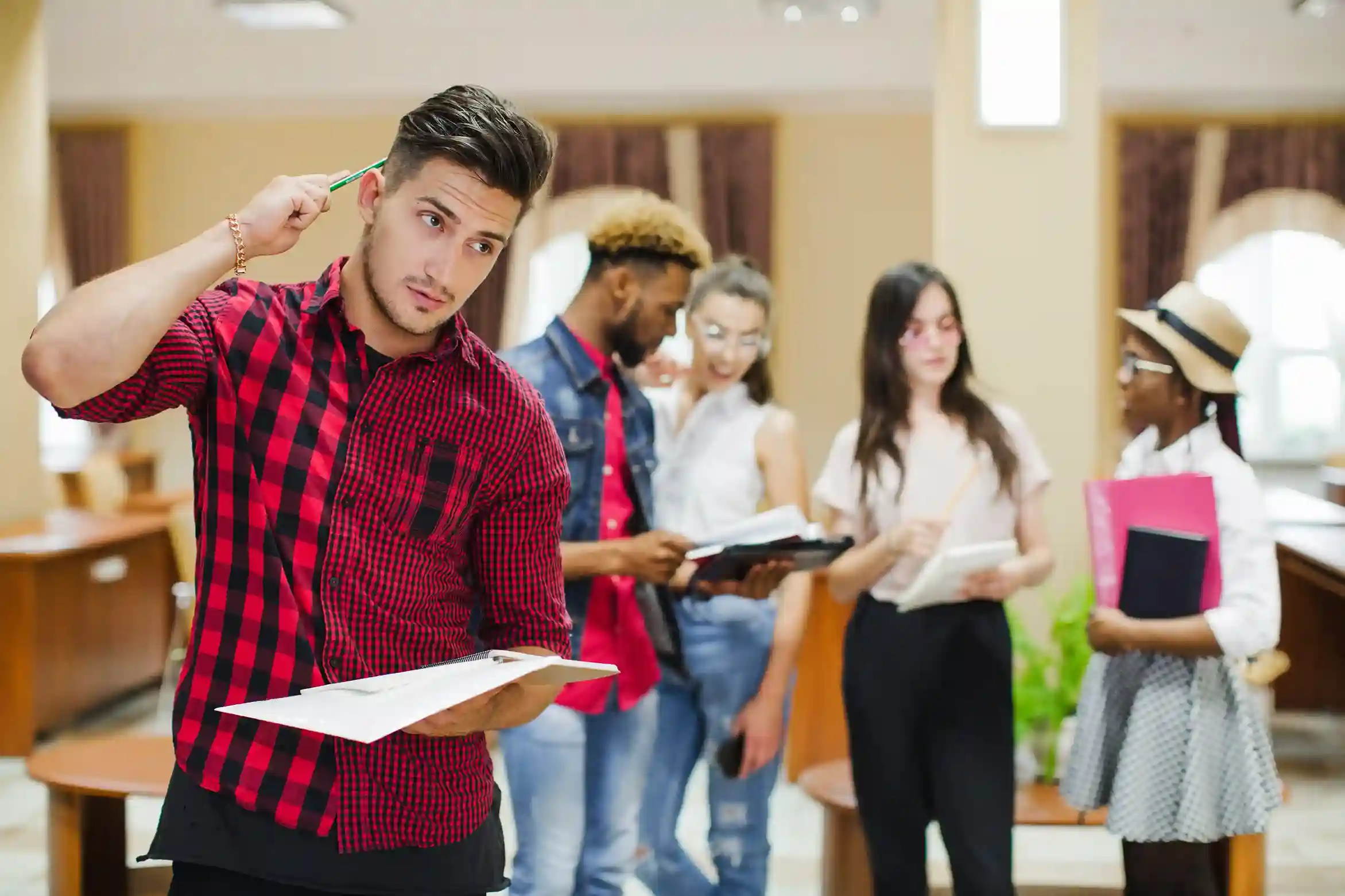 A group of students discussing their studies in a library, exploring whether a distance education degree is valid in India for career growth and job opportunities.